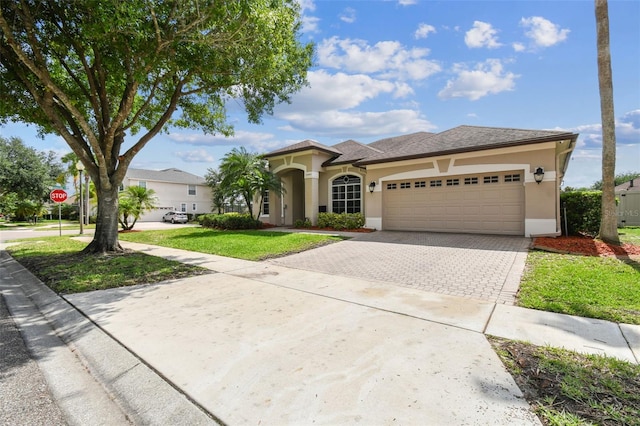 14003 Sobrado Dr, Orlando, FL 32837 - view of front of home featuring driveway, stucco siding, a garage, and a front lawn