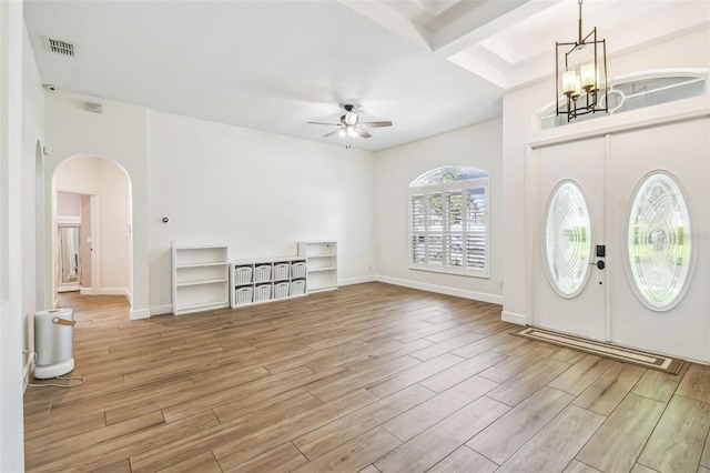 14003 Sobrado Dr, Orlando, FL 32837 - foyer entrance with ceiling fan, arched walkways, light wood-style flooring, a chandelier, and baseboards