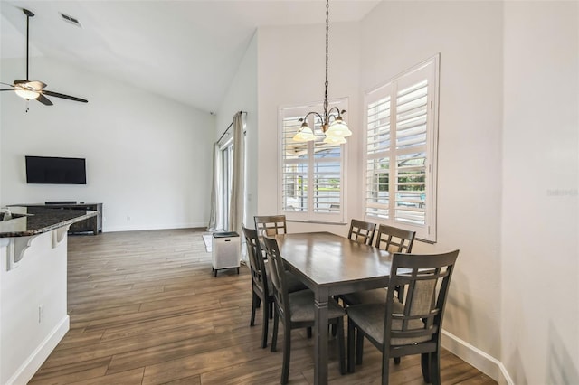 14003 Sobrado Dr, Orlando, FL 32837 - dining room featuring ceiling fan, high vaulted ceiling, dark wood-style flooring, a chandelier, and baseboards