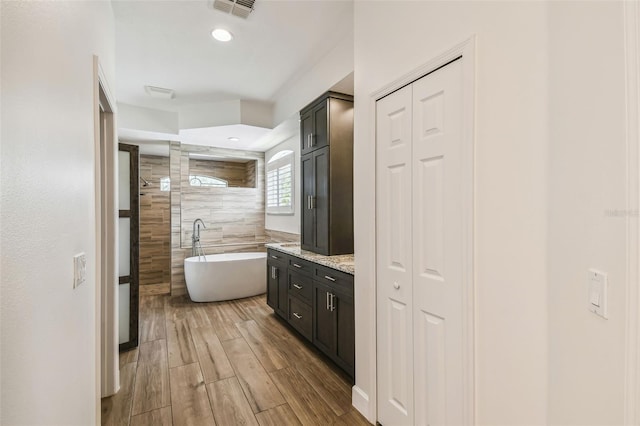 14003 Sobrado Dr, Orlando, FL 32837 - bathroom featuring a soaking tub, wood finished floors, vanity, and a tile shower