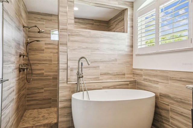 14003 Sobrado Dr, Orlando, FL 32837 - full bathroom featuring tiled shower, tile walls, and a freestanding bath