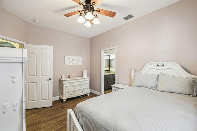 14003 Sobrado Dr, Orlando, FL 32837 - bedroom with dark wood finished floors, baseboards, a ceiling fan, and ensuite bathroom