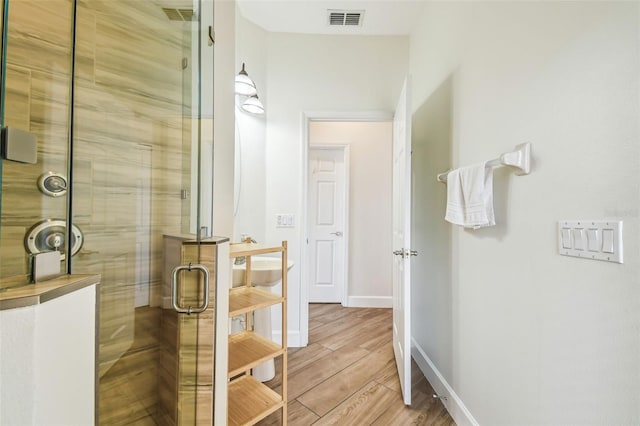 14003 Sobrado Dr, Orlando, FL 32837 - bathroom with a shower stall, wood finished floors, and baseboards