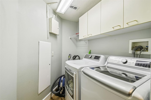 14003 Sobrado Dr, Orlando, FL 32837 - laundry area featuring cabinet space, separate washer and dryer, wood finished floors, and baseboards
