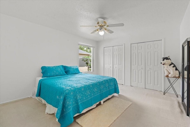 1240 Falconcrest Blvd, Apopka, FL 32712 - carpeted bedroom with multiple closets, a textured ceiling, and a ceiling fan