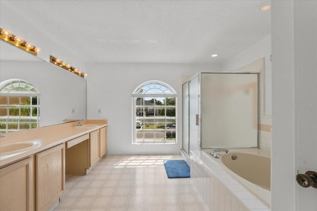 1240 Falconcrest Blvd, Apopka, FL 32712 - full bathroom with healthy amount of natural light, double vanity, a bath, a shower stall, and a textured ceiling