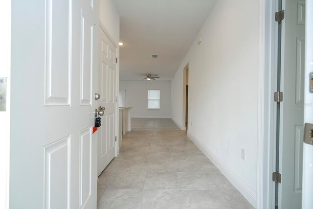 corridor featuring light tile patterned floors