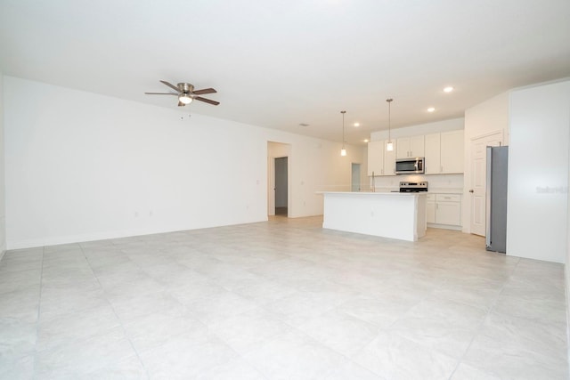 unfurnished living room with a ceiling fan and recessed lighting