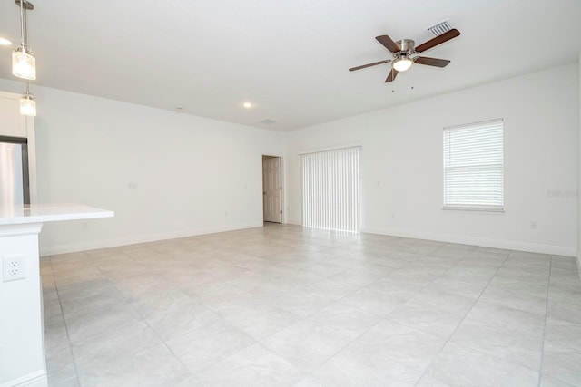 unfurnished living room with a ceiling fan, recessed lighting, and baseboards