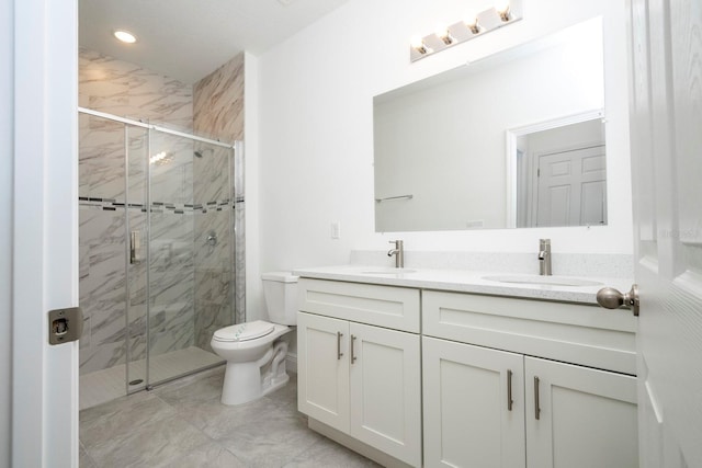 bathroom featuring toilet, a marble finish shower, and a sink