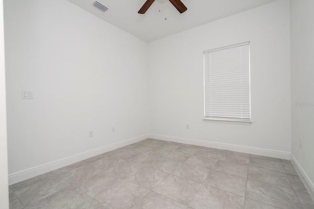 unfurnished room featuring ceiling fan and baseboards