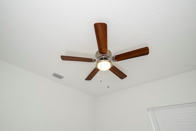 room details featuring visible vents and a ceiling fan