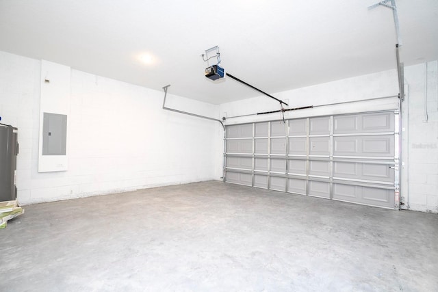 garage featuring a garage door opener, electric panel, and concrete block wall