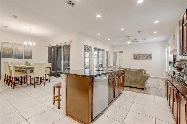 17084 Harbor Oak Pkwy, Winter Garden, FL 34787 - kitchen with dishwasher, a breakfast bar area, a sink, a chandelier, and open floor plan