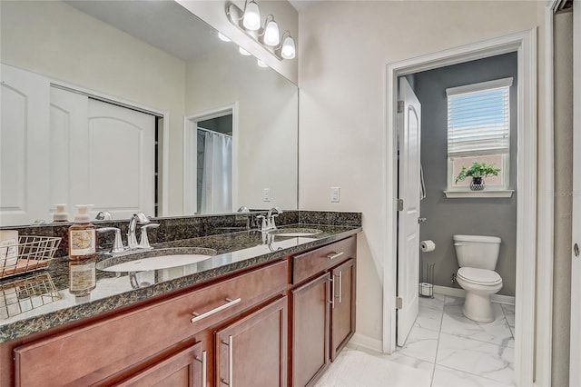 17084 Harbor Oak Pkwy, Winter Garden, FL 34787 - full bathroom featuring marble finish flooring, toilet, baseboards, and double vanity