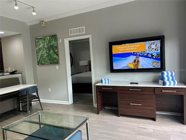14501 Grove Resort Unit 1409, Winter Garden, FL 34787 - living area with a desk, light wood finished floors, track lighting, and baseboards