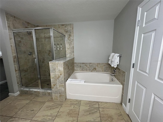 14501 Grove Resort Unit 1409, Winter Garden, FL 34787 - full bath with a shower stall, a bath, and a textured ceiling