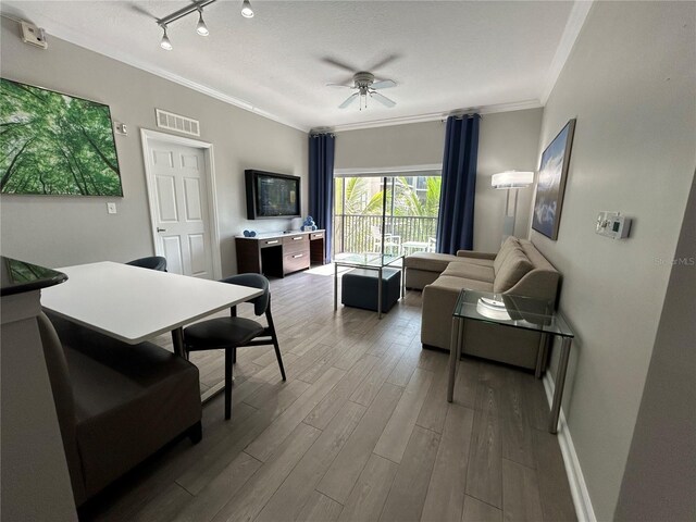 14501 Grove Resort Unit 1409, Winter Garden, FL 34787 - living area with crown molding, ceiling fan, wood finished floors, rail lighting, and baseboards