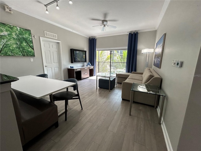 14501 Grove Resort Unit 1409, Winter Garden, FL 34787 - living room with ornamental molding, wood finished floors, ceiling fan, track lighting, and baseboards