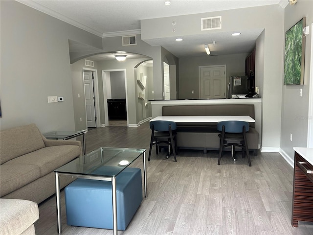 14501 Grove Resort Unit 1409, Winter Garden, FL 34787 - living room featuring arched walkways, light wood-type flooring, ornamental molding, baseboards, and recessed lighting