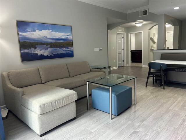 14501 Grove Resort Unit 1409, Winter Garden, FL 34787 - living room featuring arched walkways, crown molding, light wood-style floors, baseboards, and recessed lighting