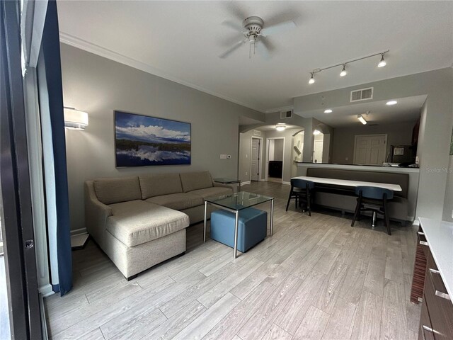14501 Grove Resort Unit 1409, Winter Garden, FL 34787 - living room with arched walkways, ceiling fan, light wood-style floors, and crown molding
