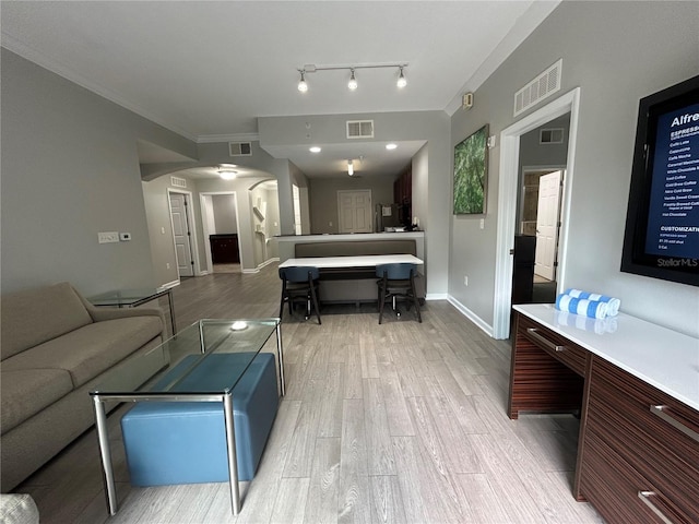14501 Grove Resort Unit 1409, Winter Garden, FL 34787 - living area with arched walkways, light wood-type flooring, and baseboards