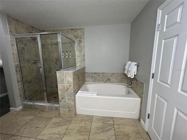 14501 Grove Resort Unit 1409, Winter Garden, FL 34787 - full bathroom featuring a shower stall, a bath, and a textured ceiling