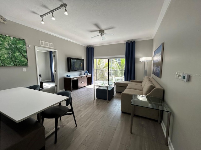 14501 Grove Resort Unit 1409, Winter Garden, FL 34787 - living room featuring crown molding, wood finished floors, a textured ceiling, a ceiling fan, and baseboards