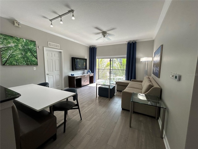14501 Grove Resort Unit 1409, Winter Garden, FL 34787 - living room with ornamental molding, ceiling fan, wood finished floors, a textured ceiling, and baseboards
