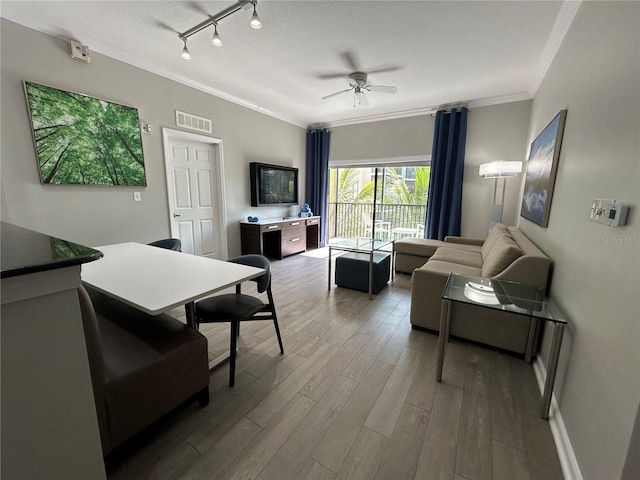 14501 Grove Resort Unit 1409, Winter Garden, FL 34787 - living area featuring ornamental molding, wood finished floors, ceiling fan, and rail lighting