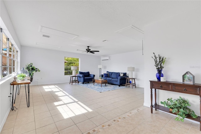 sitting room featuring attic access, light tile patterned floors, and baseboards