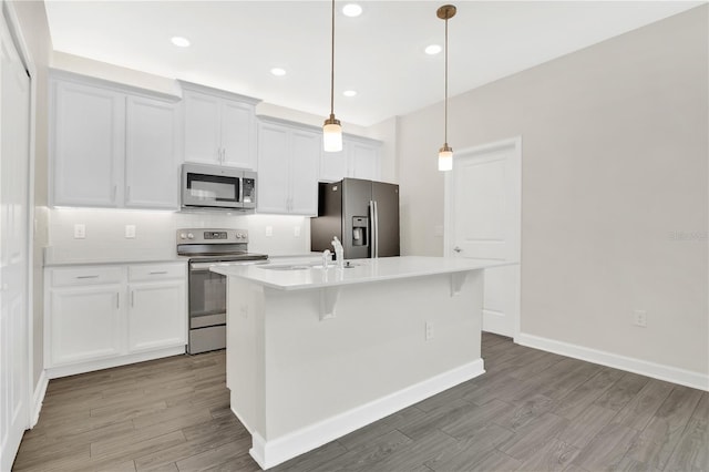 15060 Book Club Rd, Winter Garden, FL 34787 - kitchen featuring appliances with stainless steel finishes, a kitchen island with sink, backsplash, white cabinetry, and recessed lighting