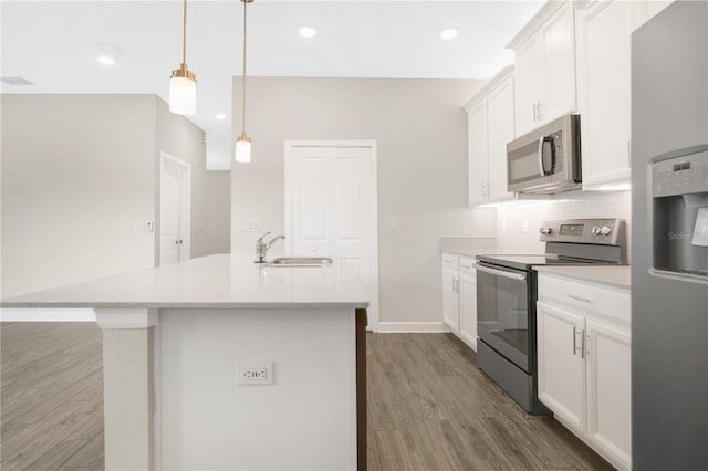 15060 Book Club Rd, Winter Garden, FL 34787 - kitchen featuring stainless steel appliances, wood finished floors, a center island with sink, white cabinetry, and recessed lighting