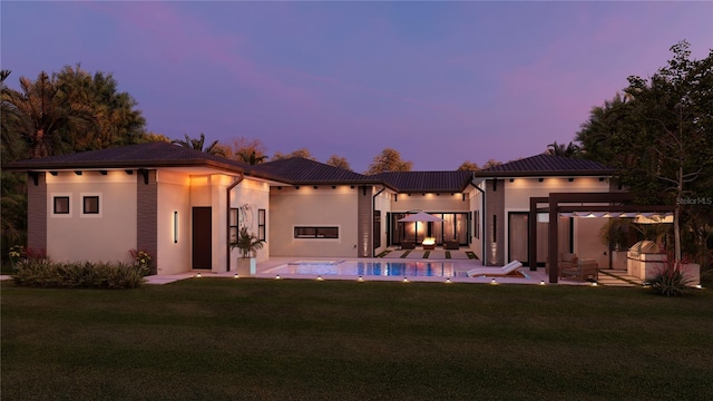 12818 Brunello Cir, Clermont, FL 34711 - back of house with a pergola, a yard, an outdoor pool, a patio area, and stucco siding