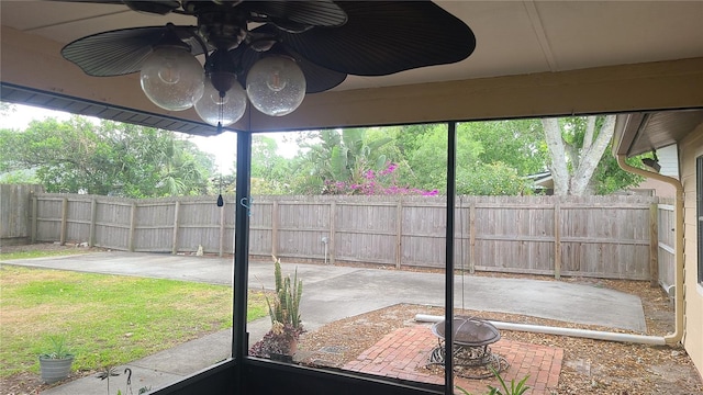 unfurnished sunroom featuring a ceiling fan
