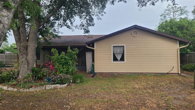 rear view of property with fence