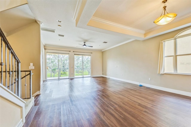 unfurnished living room featuring wood finished floors, crown molding, ceiling fan, and baseboards