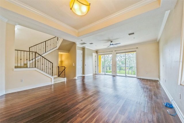 unfurnished living room featuring wood finished floors, baseboards, stairs, and crown molding