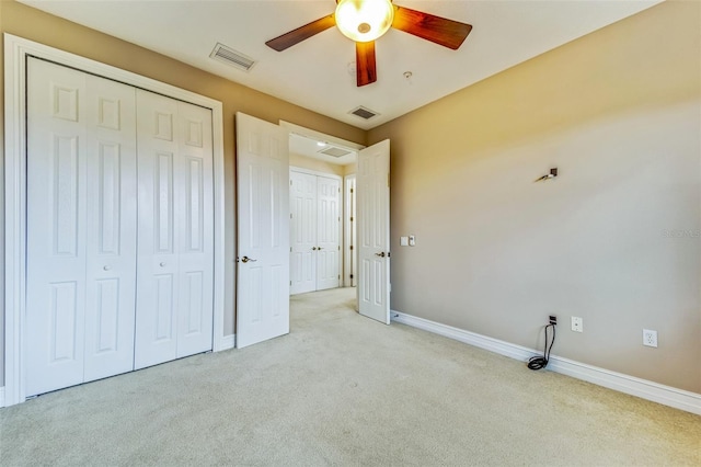 unfurnished bedroom featuring carpet floors, a closet, baseboards, and ceiling fan