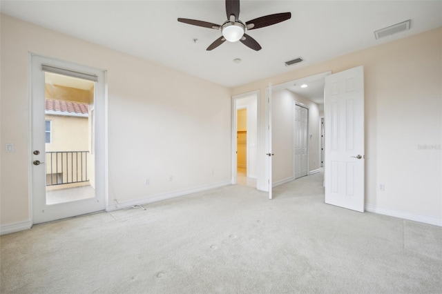 unfurnished bedroom featuring light carpet and baseboards
