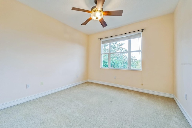 unfurnished room with light carpet, ceiling fan, and baseboards