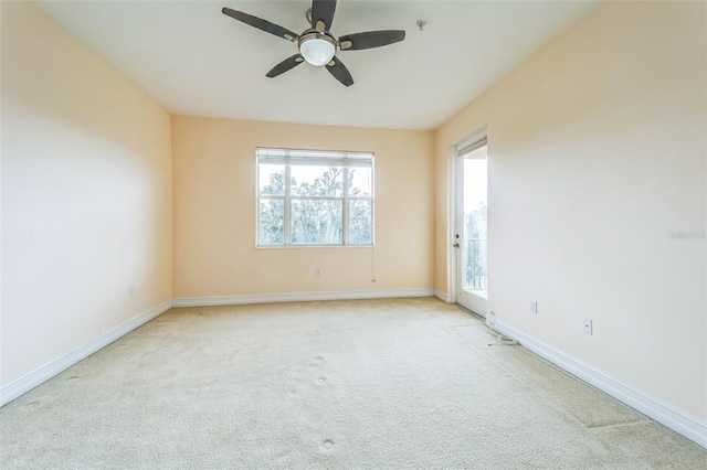 unfurnished room with ceiling fan, baseboards, and light colored carpet