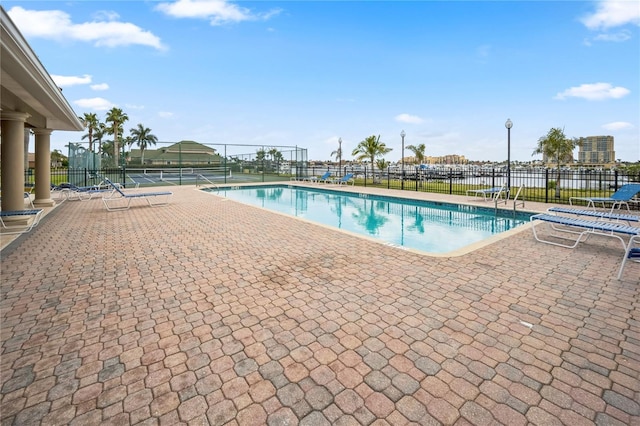 community pool featuring fence and a patio area