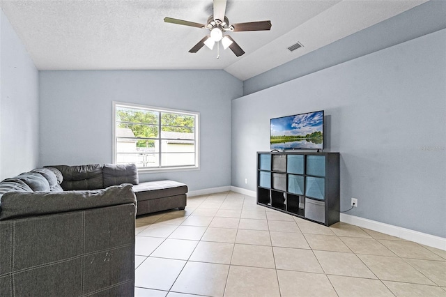 living area featuring ceiling fan, light tile patterned floors, lofted ceiling, and baseboards