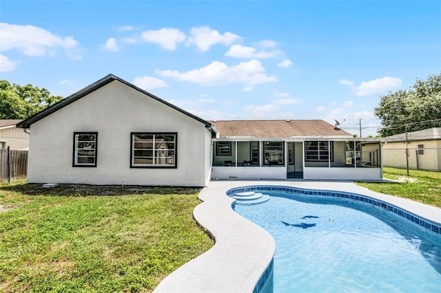 rear view of property with a sunroom