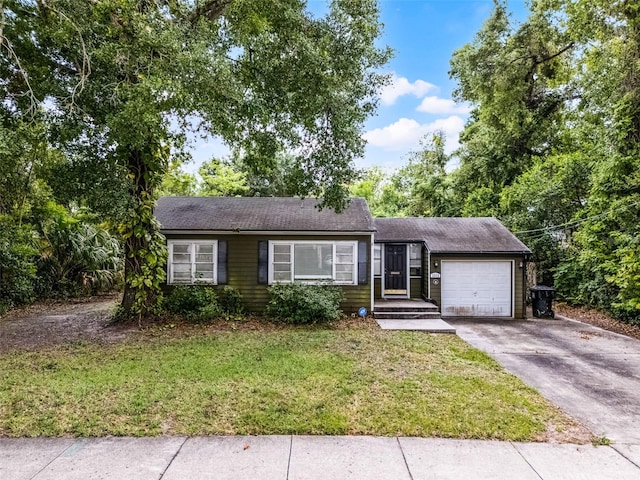 ranch-style house with an attached garage, driveway, a front yard, and roof with shingles