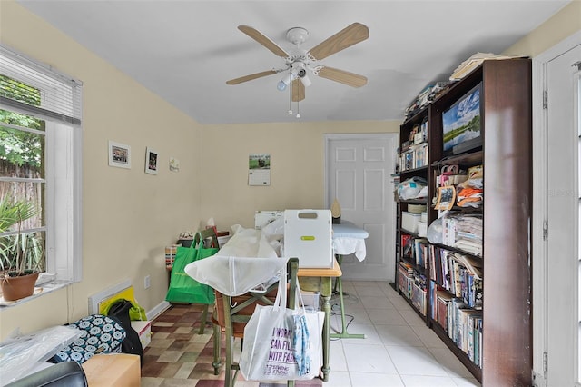 home office with ceiling fan and light tile patterned floors