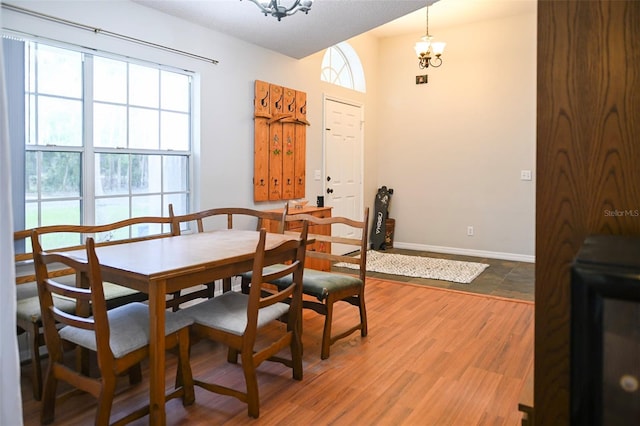 1430 Arrowhead Trl, Deltona, FL 32725 - dining room featuring a chandelier, baseboards, and light wood finished floors