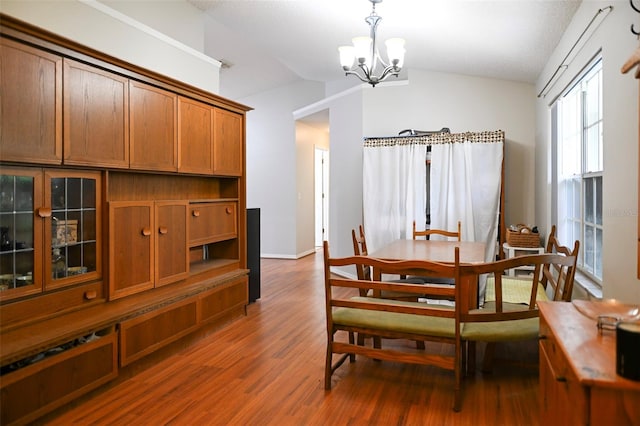 1430 Arrowhead Trl, Deltona, FL 32725 - dining area featuring lofted ceiling, a chandelier, wood finished floors, and baseboards